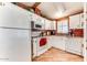 Well-maintained kitchen features white cabinets, appliances, and a view to the side yard from the window at 17200 W Bell Rd # 2221, Surprise, AZ 85374