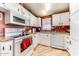 Functional kitchen features white appliances, ample cabinetry, and natural light from the window at 17200 W Bell Rd # 2221, Surprise, AZ 85374