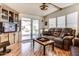 Inviting living room with hardwood floors, a comfortable couch, and natural light from the sliding glass door at 17200 W Bell Rd # 2221, Surprise, AZ 85374