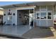 Welcoming covered entrance featuring a spacious porch, charming decor, and gray painted exterior with manicured gravel at 17200 W Bell Rd # 846, Surprise, AZ 85374