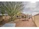 Spacious backyard with desert landscaping, outdoor dining area, a hammock, and a play area for Gathering fun at 17526 W Coyote Trail Dr, Goodyear, AZ 85338