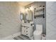 Stylish bathroom with patterned wallpaper, elegant lighting, and modern fixtures at 17526 W Coyote Trail Dr, Goodyear, AZ 85338