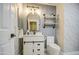 Beautiful bathroom features a white vanity with marble countertop and geometric wallpaper at 17526 W Coyote Trail Dr, Goodyear, AZ 85338