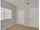 Bright bedroom features closet with sliding doors, ceiling fan, and neutral color palette at 17526 W Coyote Trail Dr, Goodyear, AZ 85338