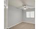 Inviting bedroom with carpet, a bright window, and a ceiling fan offering a comfortable retreat at 17526 W Coyote Trail Dr, Goodyear, AZ 85338