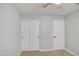 Bedroom features closet with sliding doors, ceiling fan, and neutral color palette at 17526 W Coyote Trail Dr, Goodyear, AZ 85338