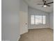 Bright bedroom with vaulted ceiling, large window and neutral carpet offering a serene living space at 17526 W Coyote Trail Dr, Goodyear, AZ 85338