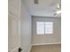 Bedroom with window offers natural light, ceiling fan, and neutral color palette at 17526 W Coyote Trail Dr, Goodyear, AZ 85338