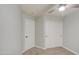 Neutral bedroom features a ceiling fan and closet with sliding doors at 17526 W Coyote Trail Dr, Goodyear, AZ 85338