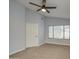 Bright bedroom with vaulted ceiling, large window and neutral carpet offering a serene living space at 17526 W Coyote Trail Dr, Goodyear, AZ 85338