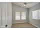 Bedroom filled with natural light from two windows, ceiling fan, and neutral palette at 17526 W Coyote Trail Dr, Goodyear, AZ 85338