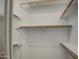 Spacious closet with adjustable shelving and wooden rods for optimal organization and storage solutions at 17526 W Coyote Trail Dr, Goodyear, AZ 85338