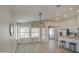 Open-concept living and dining area showcasing modern light fixture and access to the kitchen at 17526 W Coyote Trail Dr, Goodyear, AZ 85338