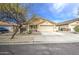 Inviting single-Gathering home with desert landscaping, mature trees, and an attached two-car garage at 17526 W Coyote Trail Dr, Goodyear, AZ 85338