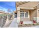 Close-up of a cozy front porch with decorative flower pots and an inviting entrance at 17526 W Coyote Trail Dr, Goodyear, AZ 85338