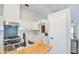 Updated kitchen featuring a center island with butcher block top, stainless steel appliances, and stylish backsplash at 17526 W Coyote Trail Dr, Goodyear, AZ 85338