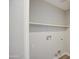 Functional laundry room with built-in shelving and convenient utility connections at 17526 W Coyote Trail Dr, Goodyear, AZ 85338