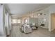 Bright, open living room featuring hardwood floors, a ceiling fan, and plenty of natural light at 17526 W Coyote Trail Dr, Goodyear, AZ 85338