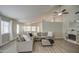 Spacious living room with hardwood floors, a ceiling fan, and comfortable seating arrangements at 17526 W Coyote Trail Dr, Goodyear, AZ 85338