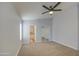 Spacious carpeted main bedroom featuring an ensuite bathroom and a mirrored closet providing ample storage at 17526 W Coyote Trail Dr, Goodyear, AZ 85338