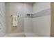 Modern tiled shower with a built-in niche and towel bar offers a spa-like experience at 17526 W Coyote Trail Dr, Goodyear, AZ 85338