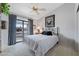 Cozy bedroom features a decorative bed frame, neutral walls, and sliding glass door to backyard at 1847 Leisure World --, Mesa, AZ 85206