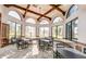 Bright dining area with arched windows, ceiling beams, and tables with chairs at 1847 Leisure World --, Mesa, AZ 85206