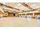 Expansive event space with a stage, beamed ceilings, chandelier lighting, and large windows, ideal for social gatherings at 1847 Leisure World --, Mesa, AZ 85206