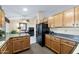 Efficient kitchen featuring wood cabinetry and essential appliances, with a view into the living area at 1847 Leisure World --, Mesa, AZ 85206