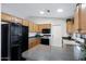 Functional kitchen featuring wood cabinets, laminate countertops, and essential appliances at 1847 Leisure World --, Mesa, AZ 85206