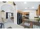 Open kitchen design showcasing wood cabinetry, black appliances, and an eat-in breakfast bar at 1847 Leisure World --, Mesa, AZ 85206