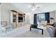 Bright living room with built-in media center, plush carpeting, and elegant decor at 1847 Leisure World --, Mesa, AZ 85206