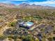 Aerial view of the community clubhouse, pool, and parking lot nestled in desert landscape at 18519 N 94Th St, Scottsdale, AZ 85255