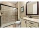 Bathroom features a glass shower, patterned tile, and granite countertops with white cabinets at 18519 N 94Th St, Scottsdale, AZ 85255