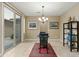 Elegant dining room featuring tile floors, modern lighting, and a sliding glass door to the backyard at 18519 N 94Th St, Scottsdale, AZ 85255