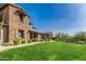 Beautiful two-story home showcasing stone accents, a lush green lawn, and professional landscaping at 18519 N 94Th St, Scottsdale, AZ 85255