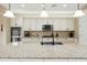 Spacious kitchen island with granite countertops, a sink, and stylish pendant lighting at 18519 N 94Th St, Scottsdale, AZ 85255