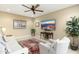 Cozy living room with comfortable seating, a ceiling fan, and a large wall-mounted TV at 18519 N 94Th St, Scottsdale, AZ 85255