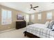 Comfortable main bedroom featuring ceiling fan, plantation shutters, and a TV for entertainment at 18519 N 94Th St, Scottsdale, AZ 85255
