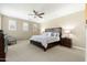 Spacious main bedroom with neutral colors, carpet floors, ceiling fan, and plantation shutters at 18519 N 94Th St, Scottsdale, AZ 85255