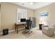 This office features a desk, a large chair, a side table, and a safe at 18519 N 94Th St, Scottsdale, AZ 85255