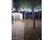 Backyard with string lights illuminating the trees and shed with pathway at 2045 W Orange Dr, Phoenix, AZ 85015