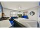 Bright bedroom featuring a blue couch, a television, a decorative wall design, and a queen sized bed at 2045 W Orange Dr, Phoenix, AZ 85015