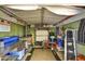 Inside the well-organized shed with tools, storage shelves, work bench, and a rolling chair at 2045 W Orange Dr, Phoenix, AZ 85015