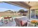 Entertaining backyard featuring a sparkling pool and a covered patio with outdoor seating and dining area at 20520 E Mockingbird Dr, Queen Creek, AZ 85142