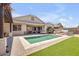 Lush backyard featuring mature landscaping, artificial turf, covered patios, and a refreshing pool at 20520 E Mockingbird Dr, Queen Creek, AZ 85142