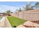 Expansive backyard featuring artificial turf, a pool, mature landscaping, and a block wall at 20520 E Mockingbird Dr, Queen Creek, AZ 85142
