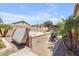 Luxurious backyard featuring a spa, lush palms, and ample patio space for relaxing and entertaining at 20520 E Mockingbird Dr, Queen Creek, AZ 85142