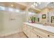Well-lit bathroom with a double vanity, decorative tile accents, and a walk-in shower at 20520 E Mockingbird Dr, Queen Creek, AZ 85142
