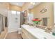 Bright bathroom featuring double sinks, tiled backsplash, white cabinets and bathtub-shower combination at 20520 E Mockingbird Dr, Queen Creek, AZ 85142